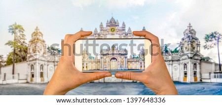 Tourist taking a picture in front of  Dolmabahce Palace Istanbul, Turkey. Travel concept 