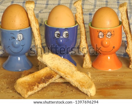 boiled eggs as soldiers in egg cups 