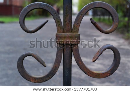 Photo background with a rusty old fence. Pattern, similar to the letter of the Russian alphabet