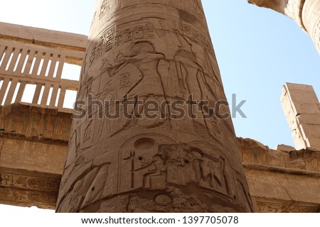 Ancient scripture on the wall at the temple of Karnak in Luxor, Egypt. Travel to the African continent for look of a UNESCO World Heritage Site.