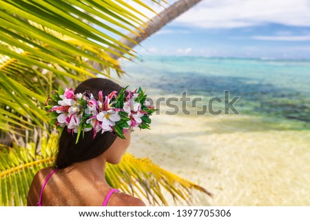 Hawaii beach woman luau dancer relaxing wearing wreath of fresh flowers on Tahiti Bora Bora, French Polynesia. Royalty-Free Stock Photo #1397705306