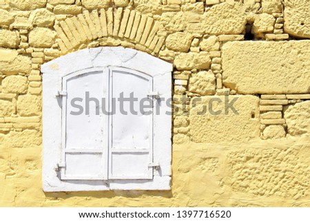 Shutters and old stone house