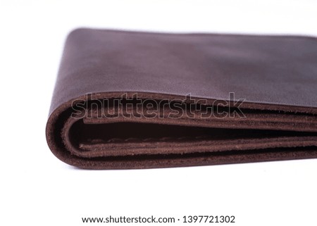 Brown handmade leather man wallet isolated on white background. Wallet is closed. Stock photo of luxury businessman accessories.