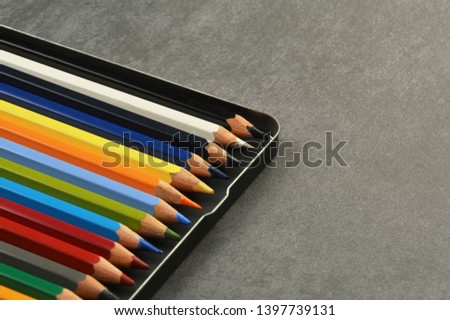 Multi colored pencils on desk with copy space