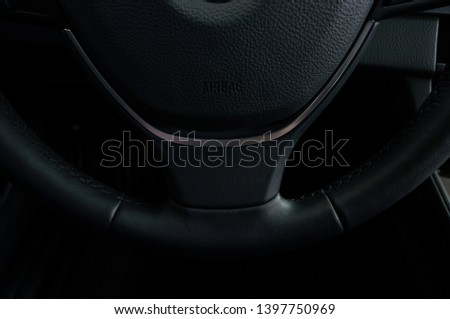 Airbag sign on steering wheel of car. Interior detail.