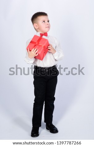 Shopping. Boxing day. New year. little boy with valentines day gift. Birthday party. tuxedo style. Happy childhood. happy child with present box. Christmas. happy retro guy go shopping.