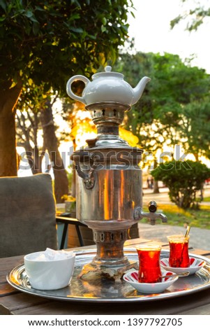 Traditional Turkish tea brewing set (Turkish: Semaver) tea garden near the sea during the sunset in Antalya. You are must taste Turkish tea! 
