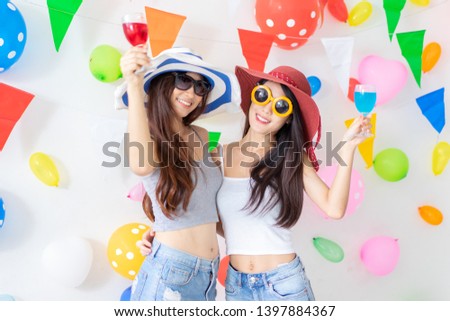 celebration new year or birthday party group of asian young woman and confetti happy,funny concept.drinking wine happy and fun in new year celebrate, color balloon  background.