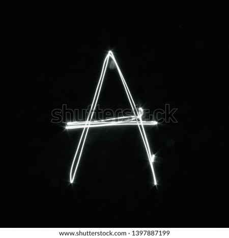 A-created by light letters - uppercase character, Pictured by light letters, painted by light, Black background light font,selective​ focus