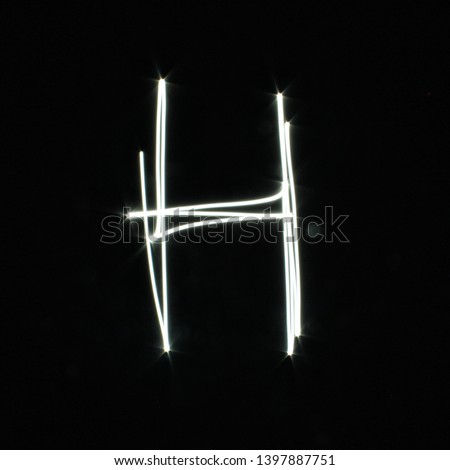 H-created by light letters - uppercase character, Pictured by light letters, painted by light, Black background light font,​selective​ focus
