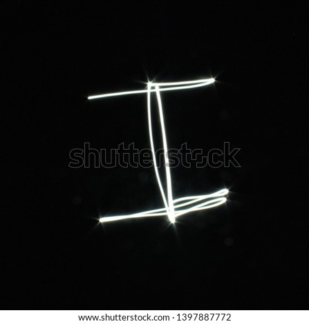 I-created by light letters - uppercase character, Pictured by light letters, painted by light, Black background light font,​selective​ focus