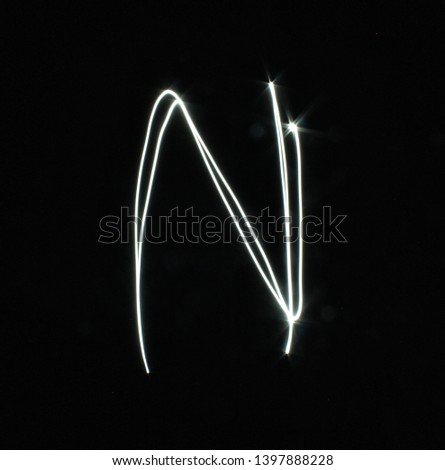 N-created by light letters - uppercase character, Pictured by light letters, painted by light, Black background light font,​selective​ focus