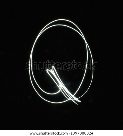 Q-created by light letters - uppercase character, Pictured by light letters, painted by light, Black background light font,​selective​ focus