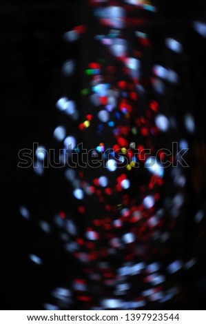 Blurred LED screen closeup. Glowing threads in a color spectrum on a black background. 