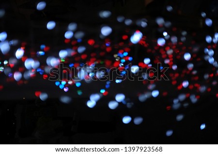 Blurred LED screen closeup. Glowing threads in a color spectrum on a black background. 