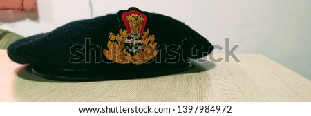 a beret cap of an Indian coast Guard officer resting on a table