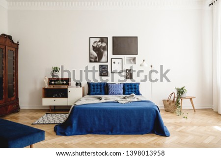 Mockup gallery on the wall of navy blue vintage bedroom in tenement house. Real photo concept