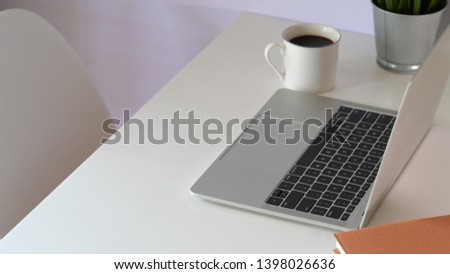 Mock up laptop on white workspace