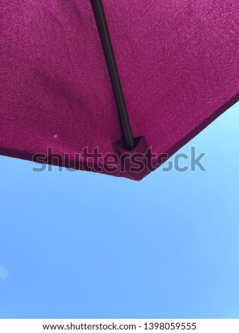 Summer patio umbrella with blue sky background