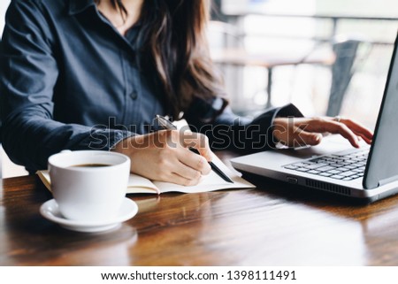 Businesswoman working at the coffee shop with laptop computer. Business financial analysis and strategy concept. Royalty-Free Stock Photo #1398111491