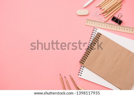 Colorful school supplies on pastel pink background. Top view, flat lay. Space for text.