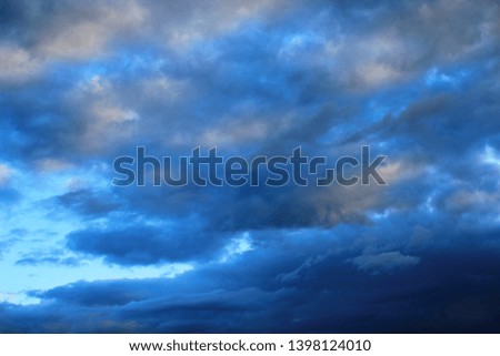 Dark clouds on blue sky
