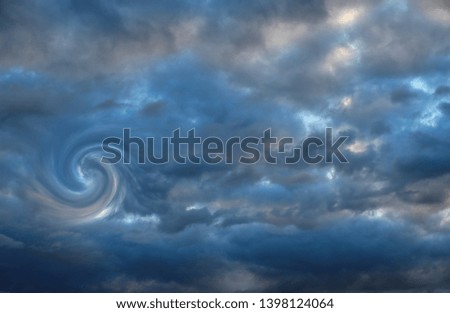 Dark clouds on blue sky