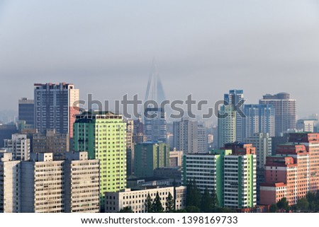 Pyongyang, DPR Korea North Korea and Taedong River in the morning fog. Modern residential complex and Ryugyong Hotel. View from Yanggakdo Hotel  Royalty-Free Stock Photo #1398169733