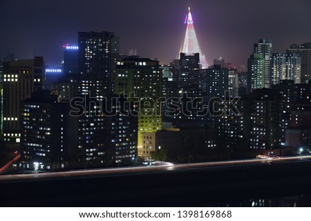 Pyongyang, DPR Korea North Korea. Night view on the modern residential complex and Ryugyong Hotel. View from Yanggakdo Hotel  Royalty-Free Stock Photo #1398169868