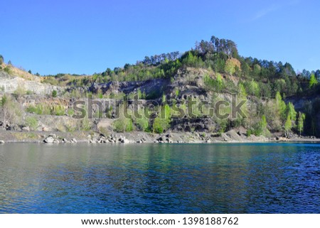 Panorama picture of stone Quarry Kosov is situated in Jihlava River valley. Lake with clear water nad forest. Spring/summer time. 