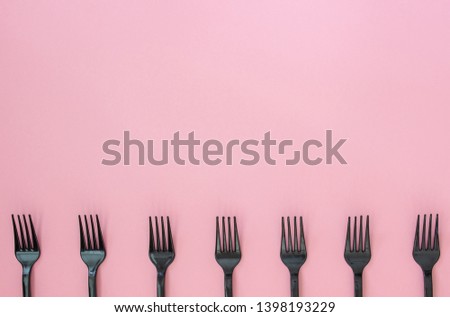 Forks on a pink background. Minimal concept. Abstract.