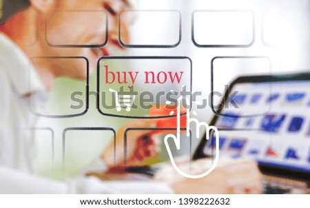 Hand icon click buy now on the icon  keyboard laptop.Hand holding credit card and using laptop,blurred background. Online shopping