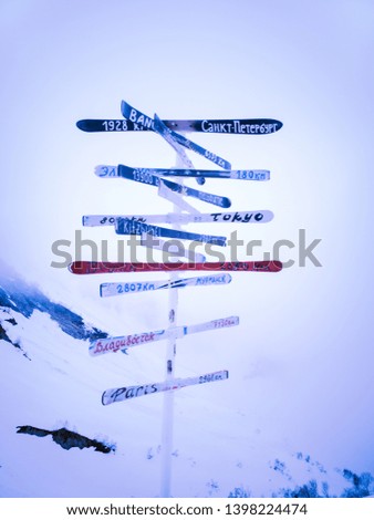 Index of ski boards with the names of different cities in the world high in the mountains of Krasnaya Polyana in Sochi