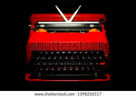 red typewriter 60s vintage valentine portable design classic icon ettore sottsass italian on black background HIGH RESOLUTION Royalty-Free Stock Photo #1398226517