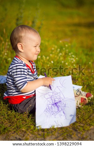 
The child draws a drawing with markers