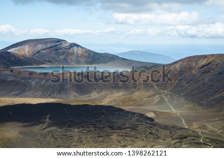 View of Blue lake from Tongariro Alpine Crossing hike with clouds above, North Island, New Zealand