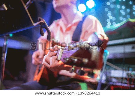 Musician playing guitar at a party.