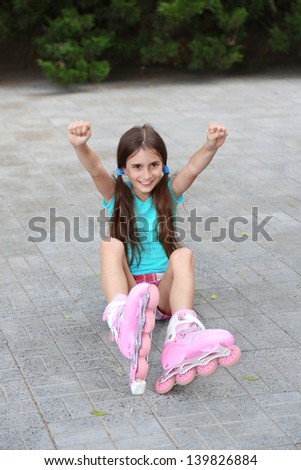Little girl in roller skates at  park