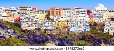 Fira or Thira, Santorini, Greece panoramic banner with white and blue colorful houses on high volcanic rocks