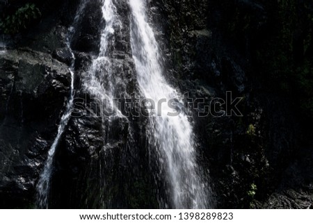 Waterfalls flow over strange rocks.