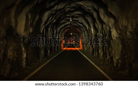 Dark endless tunnel through the mountain, Faroe islands
