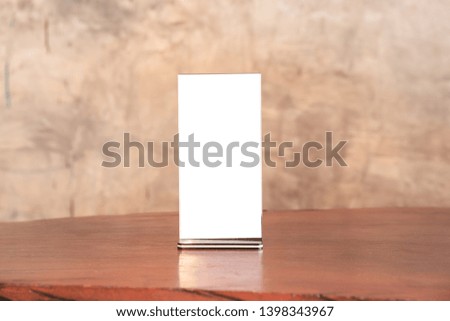 Menu frame standing on wood table in coffee shop. space for text marketing promotion  