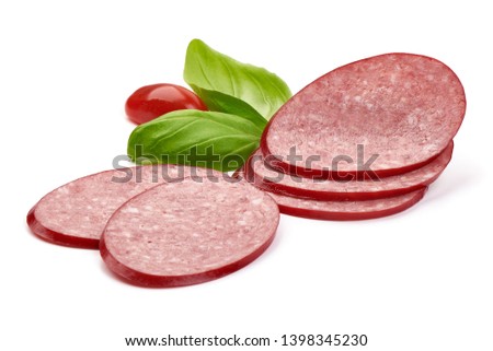 Sliced dry salami sausage with basil leaves, close-up, isolated on white background.