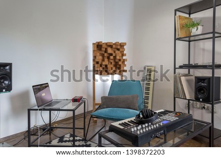 Professional digital studio at home for recording. He has instruments and midi controller. Music production concept.