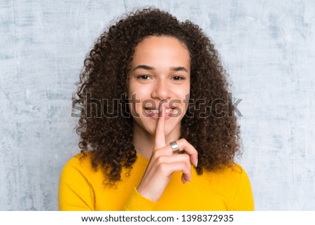 Dominican woman over isolated green background doing silence gesture