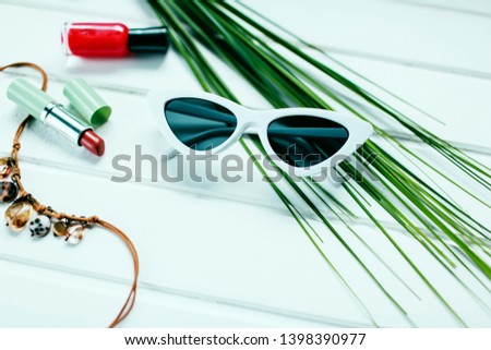 white women's sunglasses
Glasses in the form of cat's eyes are next to the makeup.
items for summer holidays
bright shine on the photo and place for text