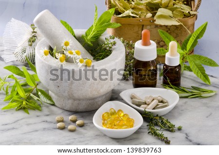 Alternative Medicine. Rosemary, mint, chamomille, thyme in a marble mortar. Essential oils and herbal supplements. Royalty-Free Stock Photo #139839763