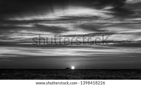 Beautiful sunset over sea in black and white. 