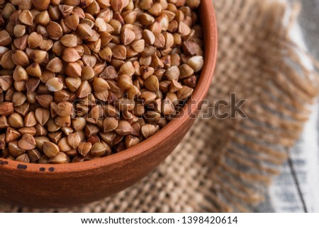 Grain buckwheat on a gray wooden background
