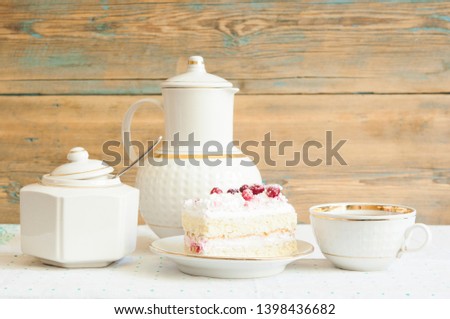 Delicious slice of red cranberry cake with table set for a typical breakfast 